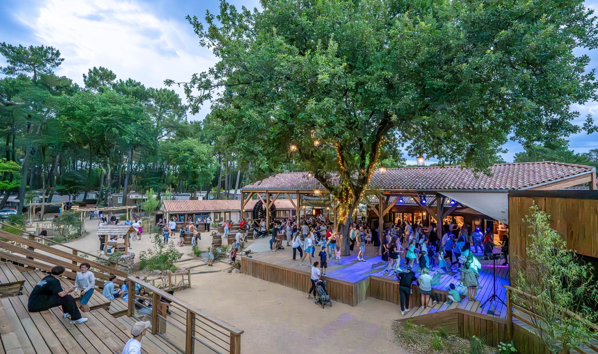Old Oak Square, stage and seating area of the entertainment space at Camping Au Bois des Biches, hosting concerts and shows under the stars of Saint-Hilaire-de-Riez